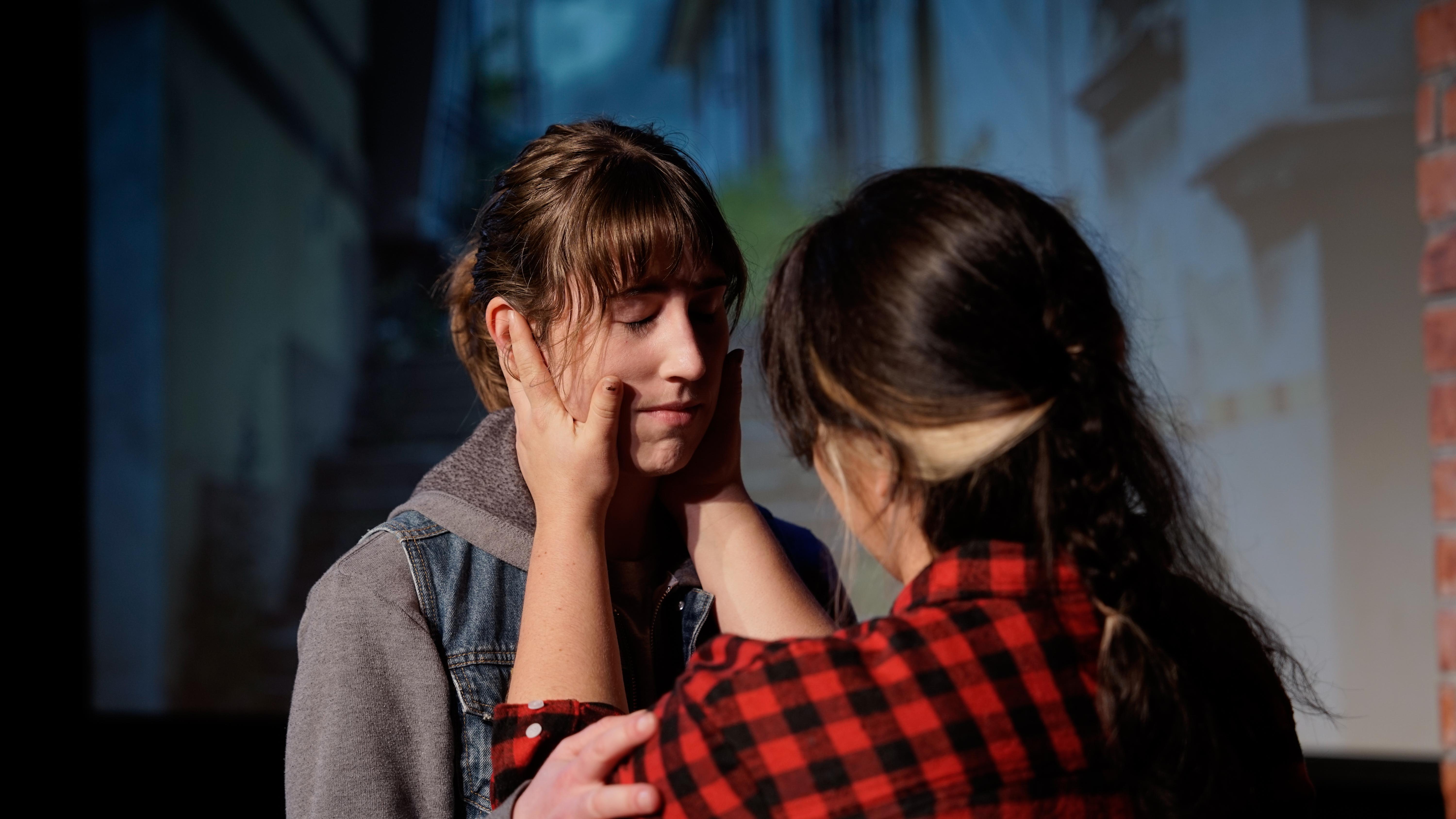 A woman gently holds Kat's face in The Rest of Us