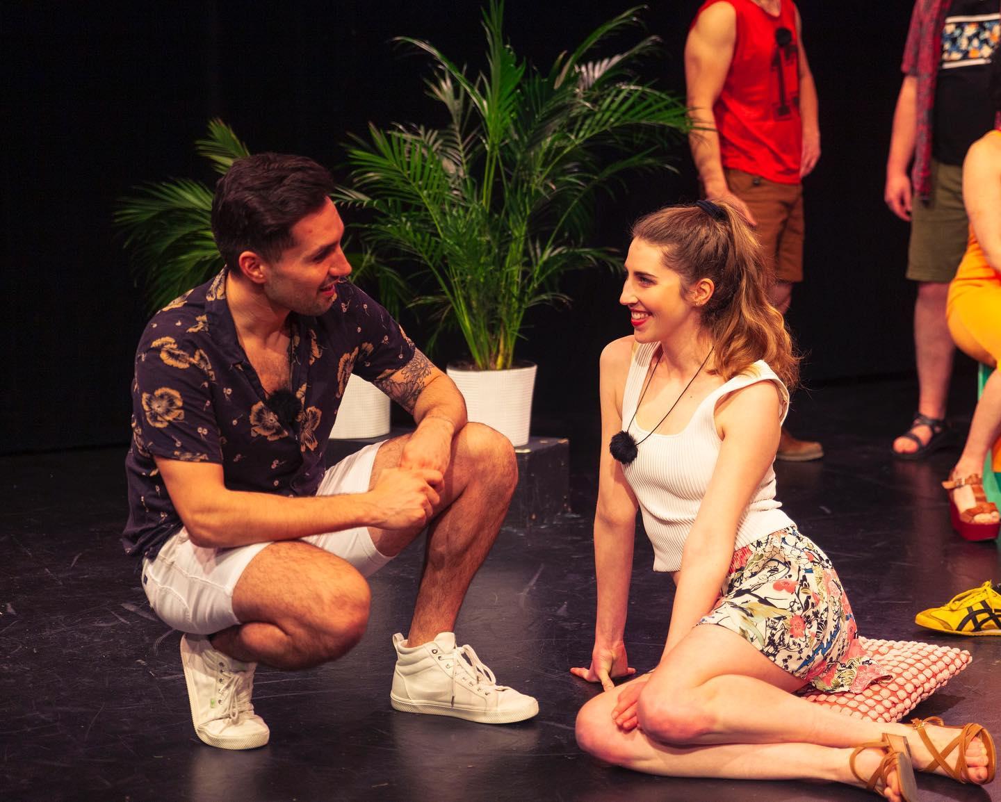 Kat flirting with kneeling man in 2Hot2Touch